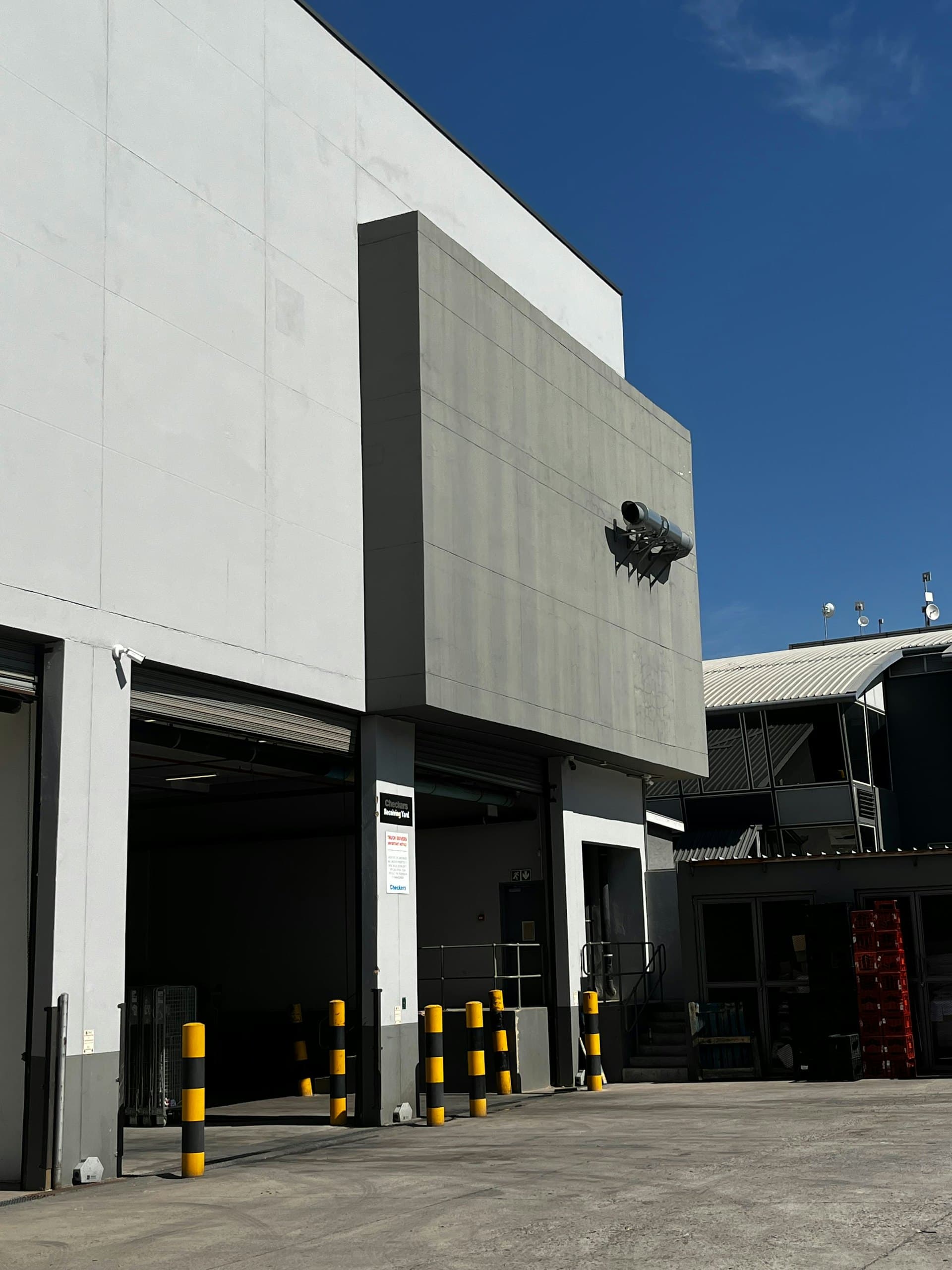 Modern industrial building exterior with a row of loading docks